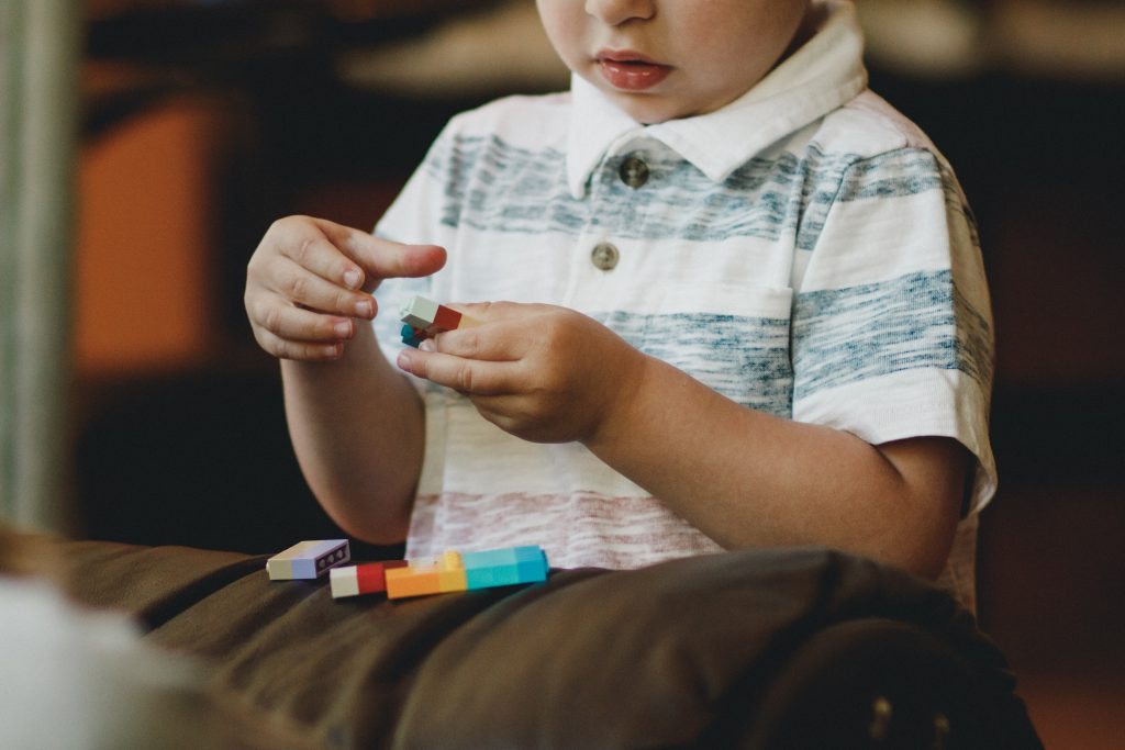 boy playing with blocks and games