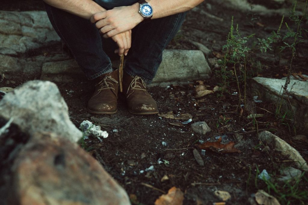 photo of feet next to carbon waste and nature that can be reduced using blockchain