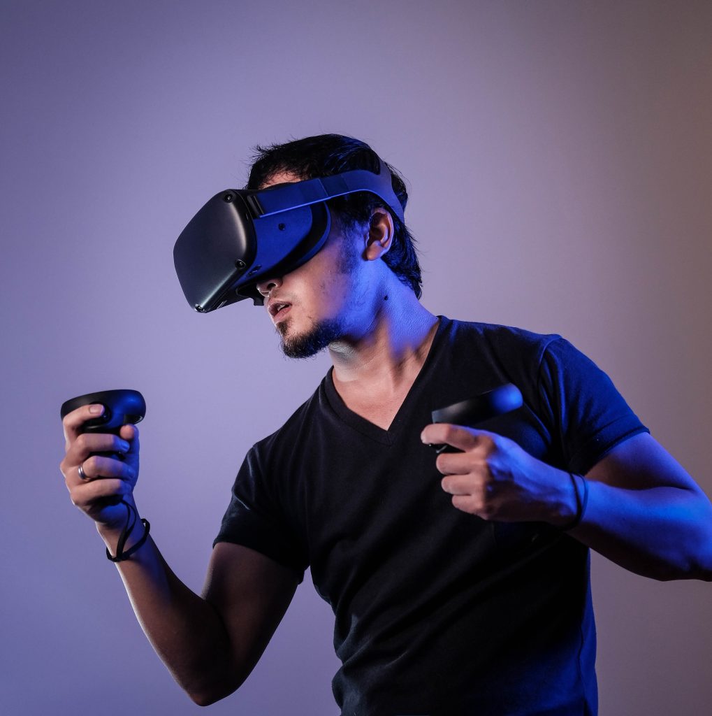 man wearing a VR headset and technological accessories to access metaverse